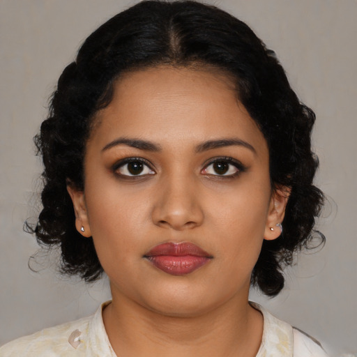 Joyful black young-adult female with medium  black hair and brown eyes