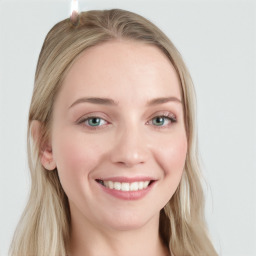 Joyful white young-adult female with long  brown hair and blue eyes