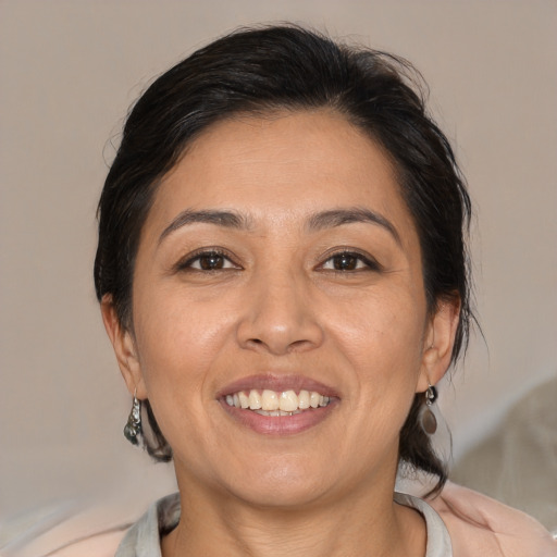 Joyful white adult female with medium  brown hair and brown eyes