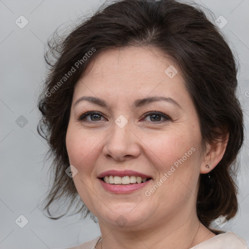 Joyful white adult female with medium  brown hair and brown eyes