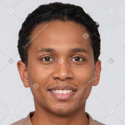 Joyful black young-adult male with short  black hair and brown eyes