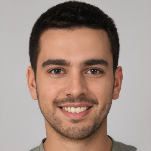 Joyful white young-adult male with short  brown hair and brown eyes