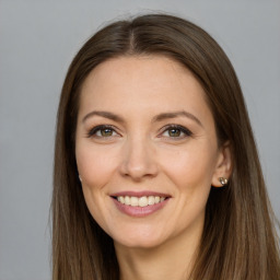 Joyful white young-adult female with long  brown hair and grey eyes