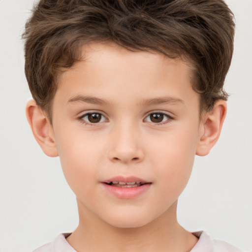 Joyful white child male with short  brown hair and brown eyes