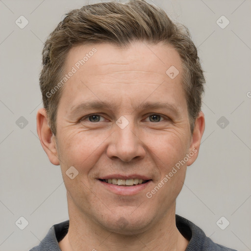 Joyful white adult male with short  brown hair and grey eyes