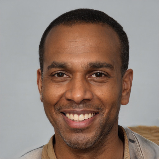 Joyful latino adult male with short  black hair and brown eyes