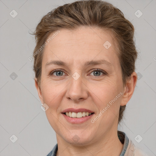 Joyful white adult female with short  brown hair and grey eyes