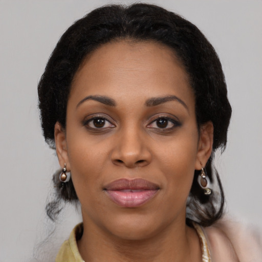 Joyful black young-adult female with medium  black hair and brown eyes