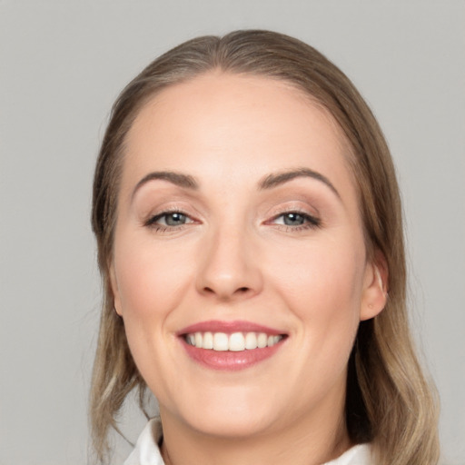 Joyful white young-adult female with medium  brown hair and grey eyes