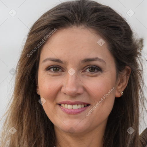 Joyful white adult female with long  brown hair and brown eyes