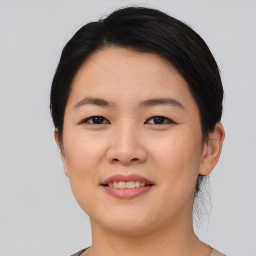 Joyful asian young-adult female with short  black hair and brown eyes
