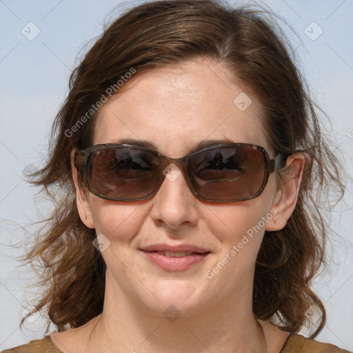 Joyful white adult female with medium  brown hair and blue eyes