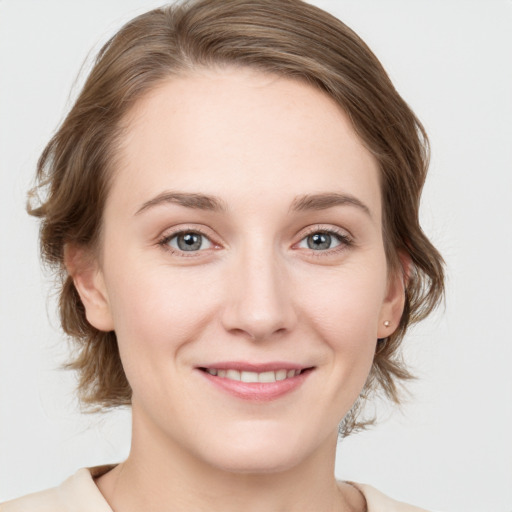 Joyful white young-adult female with medium  brown hair and blue eyes