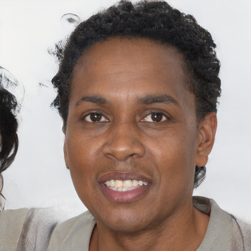Joyful black adult male with short  black hair and brown eyes