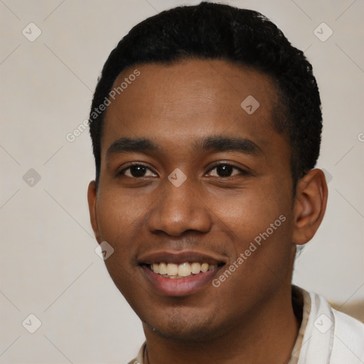 Joyful black young-adult male with short  black hair and brown eyes