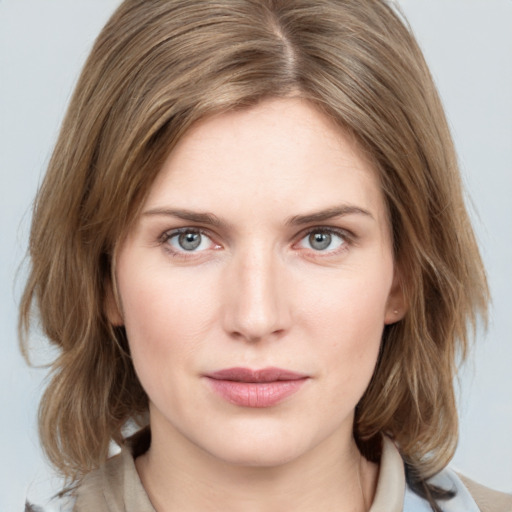 Joyful white young-adult female with medium  brown hair and blue eyes