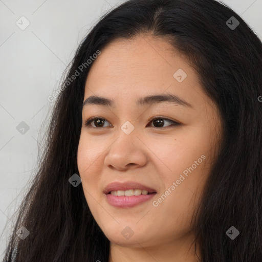 Joyful asian young-adult female with long  black hair and brown eyes