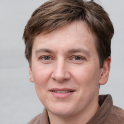 Joyful white adult male with short  brown hair and grey eyes