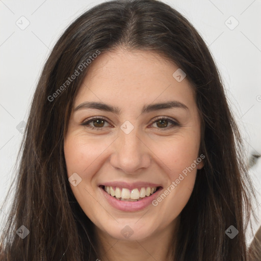 Joyful white young-adult female with long  brown hair and brown eyes