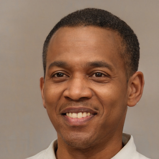 Joyful latino adult male with short  black hair and brown eyes