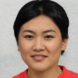 Joyful asian young-adult female with medium  black hair and brown eyes