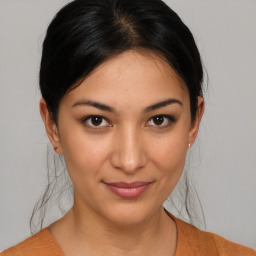 Joyful latino young-adult female with medium  brown hair and brown eyes