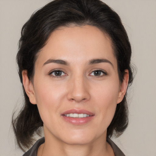 Joyful white young-adult female with medium  brown hair and brown eyes