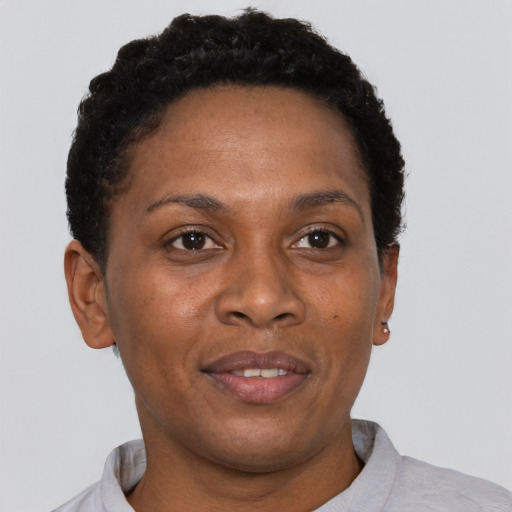 Joyful black adult female with short  brown hair and brown eyes