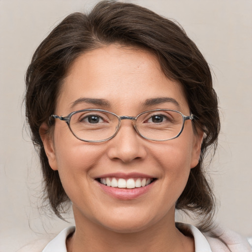 Joyful white adult female with medium  brown hair and brown eyes