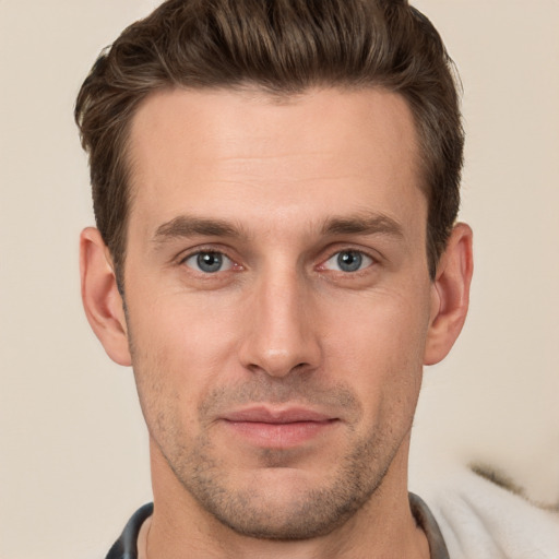 Joyful white young-adult male with short  brown hair and grey eyes