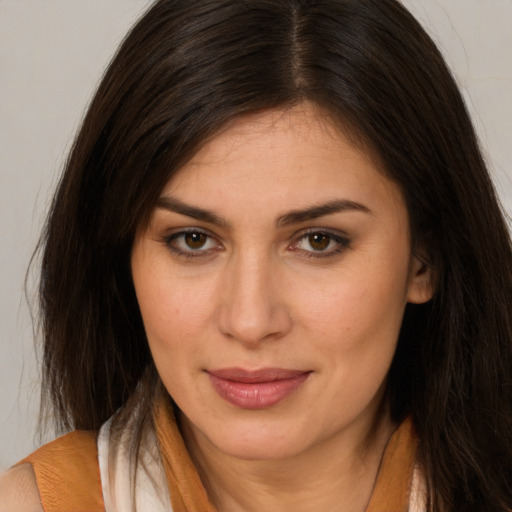 Joyful white young-adult female with long  brown hair and brown eyes