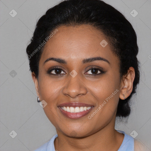 Joyful black young-adult female with medium  black hair and brown eyes