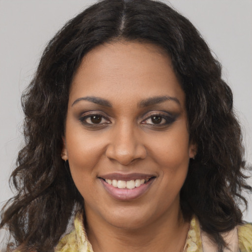 Joyful black young-adult female with medium  brown hair and brown eyes