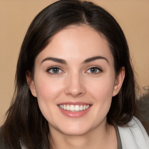 Joyful white young-adult female with medium  brown hair and brown eyes