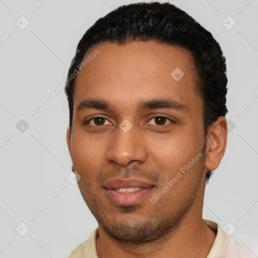 Joyful latino young-adult male with short  black hair and brown eyes