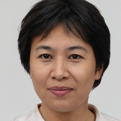 Joyful asian adult female with short  brown hair and brown eyes