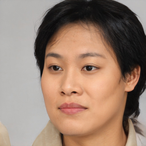 Joyful asian young-adult female with medium  brown hair and brown eyes