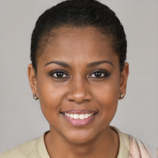 Joyful black young-adult female with short  brown hair and brown eyes