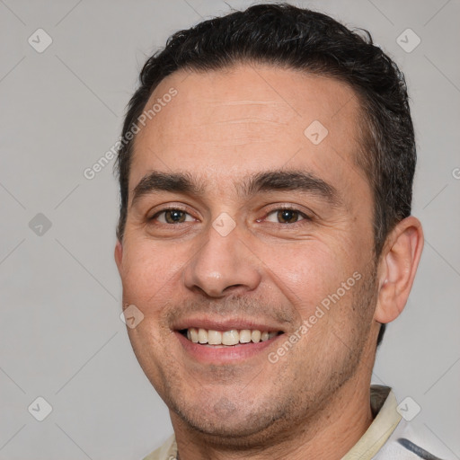 Joyful white adult male with short  brown hair and brown eyes