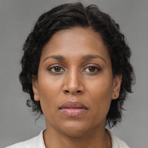 Neutral black young-adult female with medium  brown hair and brown eyes