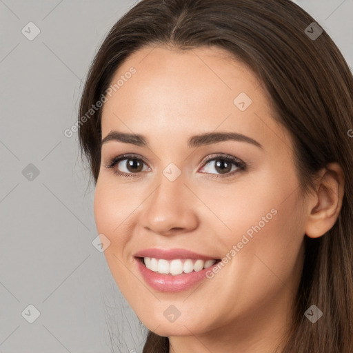 Joyful white young-adult female with long  brown hair and brown eyes