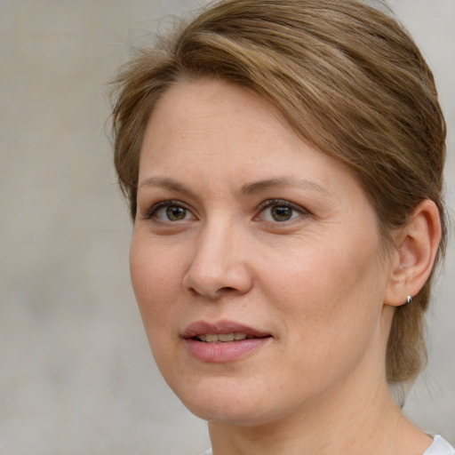 Joyful white adult female with medium  brown hair and brown eyes