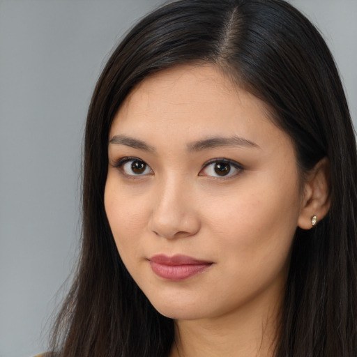 Joyful asian young-adult female with long  brown hair and brown eyes