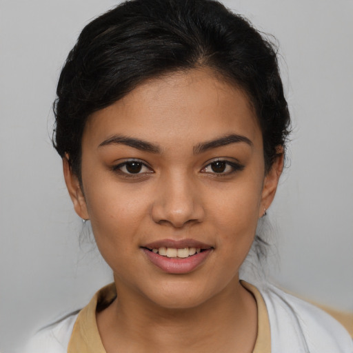 Joyful latino young-adult female with medium  brown hair and brown eyes