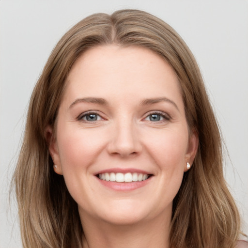 Joyful white young-adult female with long  brown hair and grey eyes