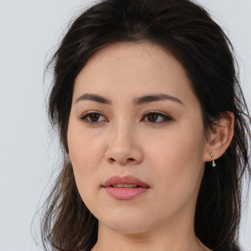 Joyful asian young-adult female with long  brown hair and brown eyes