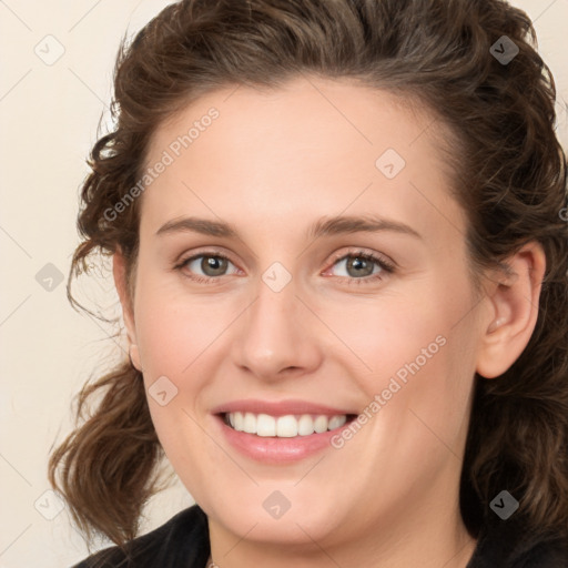 Joyful white young-adult female with long  brown hair and green eyes