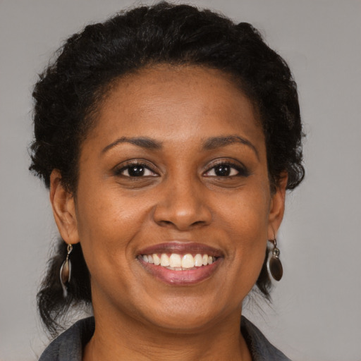 Joyful black young-adult female with medium  brown hair and brown eyes