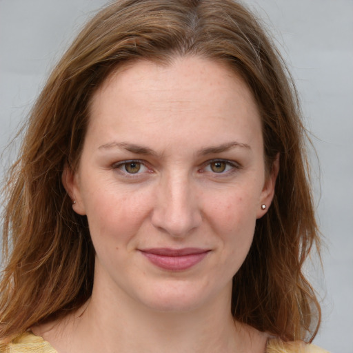 Joyful white young-adult female with medium  brown hair and grey eyes