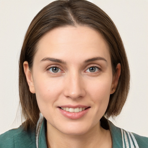 Joyful white young-adult female with medium  brown hair and grey eyes